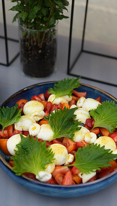 Black and white photo of a women performing modern dance on a dark background.