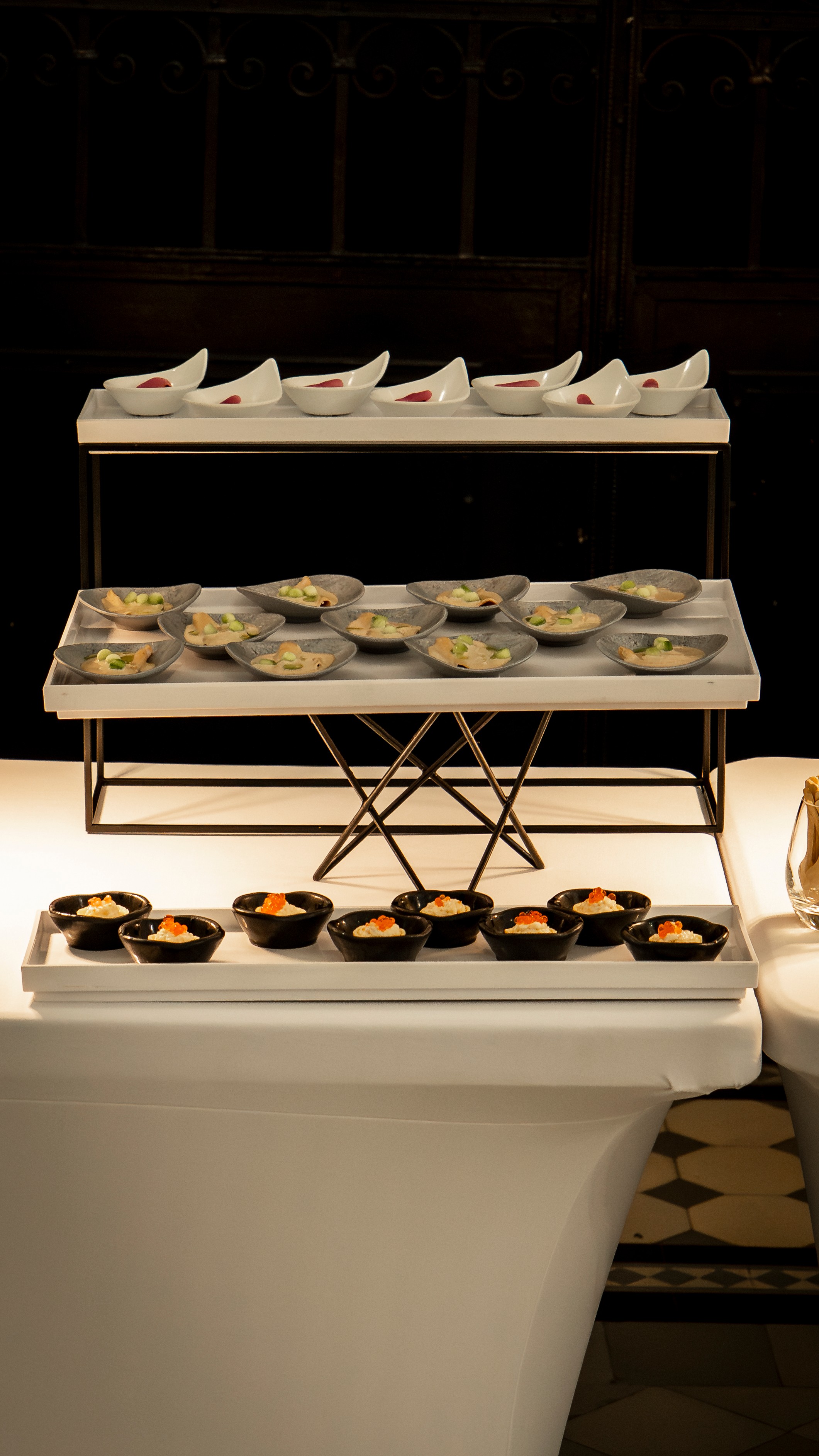 Black and white photo of a women performing modern dance on a dark background.