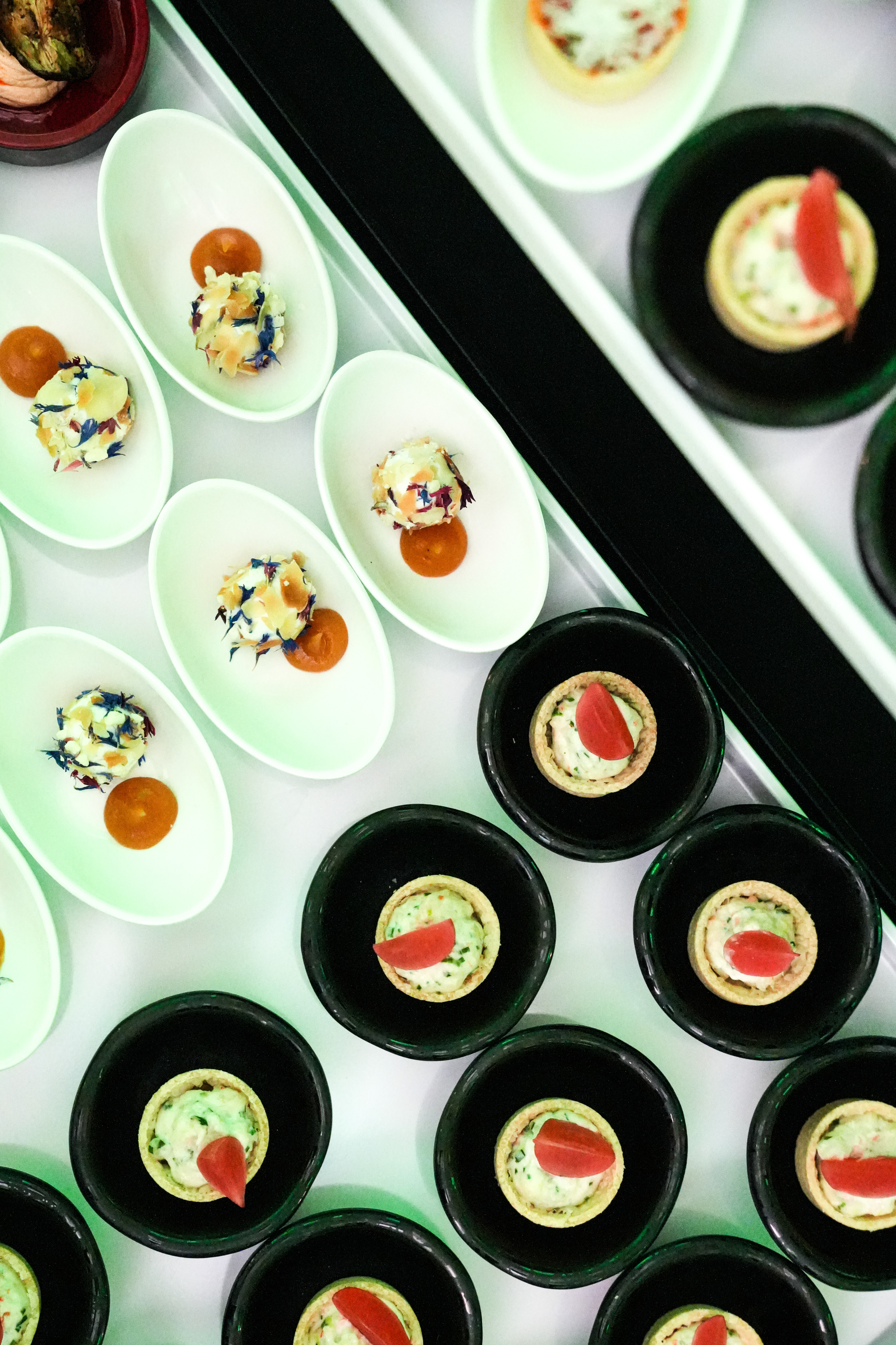 Black and white photo of a women performing modern dance on a dark background.