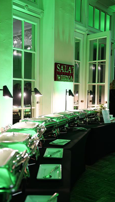 Black and white photo of a women performing modern dance on a dark background.