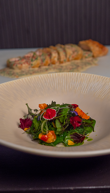Black and white photo of a women performing modern dance on a dark background.