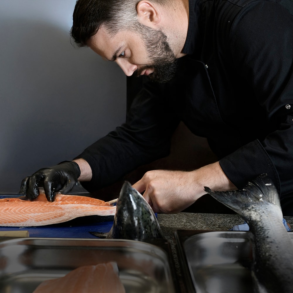 Black and white photo of a women performing modern dance on a dark background.