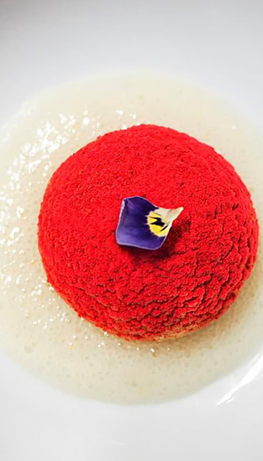 Black and white photo of a women performing modern dance on a dark background.