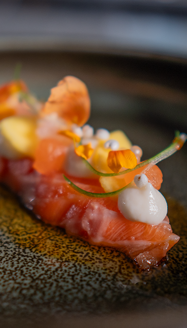 Black and white photo of a women performing modern dance on a dark background.